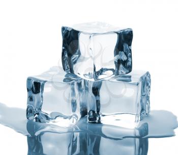 Three ice cubes and water on glass table isolated on white background