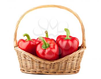 Sweet red pepper in wicker basket on white background