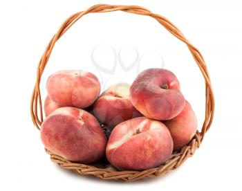 Paraguayos flat peaches in wicker basket isolated on white background