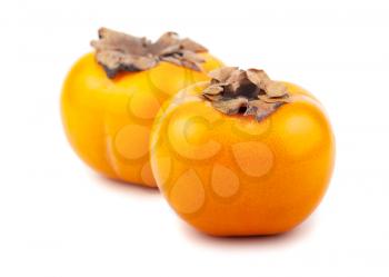 Pair of ripe japanese persimmons on white background