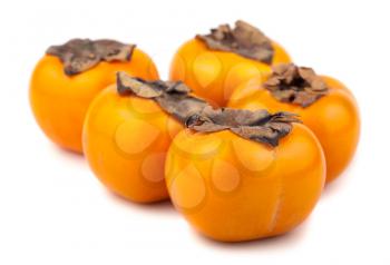 Five persimmon fruits isolated on the white background