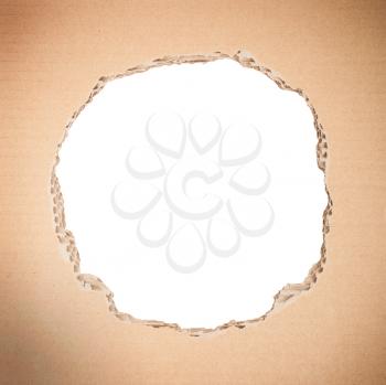 White circle shape breakthrough in beige cardboard