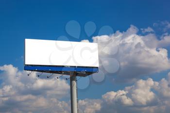 Blank billboard on blue sky with clouds for your advertisement 