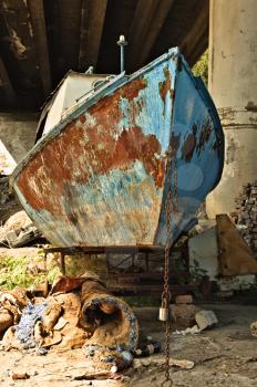 The old rusty boat under the bridge