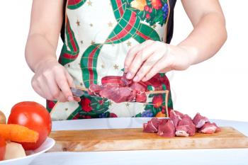 Royalty Free Photo of a Woman Cutting Meat