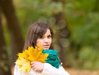 Royalty Free Photo of a Woman Holding a Scarf and Leaves