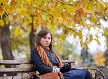 Royalty Free Photo of a Woman Sitting on a Bench