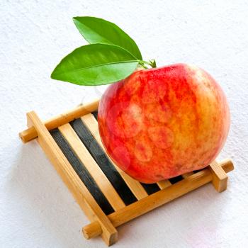 Royalty Free Photo of an Apple on a Wooden Plate