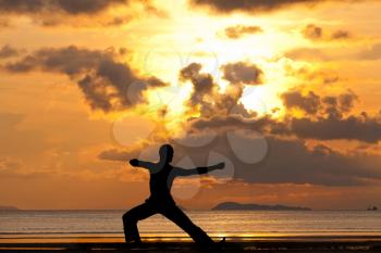 Royalty Free Photo of a Man Doing Yoga on a Beach