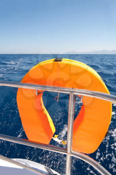 Royalty Free Photo of an Orange Lifebuoy on a Sailing Ship