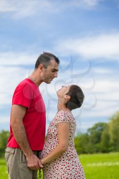 Royalty Free Photo of a Husband Looking at His Pregnant Wife