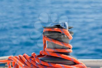 Winch with red rope on yacht in the sea
