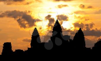 Angkor Wat temple silhouette with sunset sky and clouds
