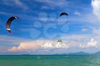 Wakeboarders jumping from water in open sea. Koh Samui, Thailand
