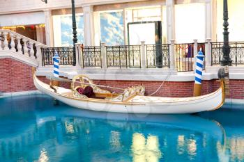 White venetian gondola imitation in Las Vegas casino, USA on blue water
