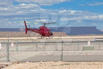 Helicopter starting from restricted fenced base near Grand Canyon
