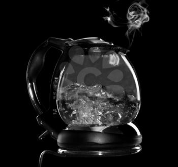 Kettle with boiling water and steam isolated with clipping path on black background