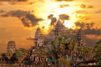 Angkor Wat temple with sunset sky and clouds
