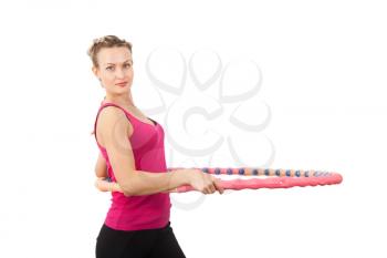Athletic young woman with hula hoop isolated on white