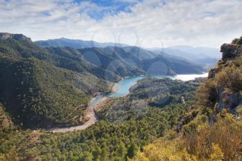 Valley with the river and cloudy sky in the Catalonian mountains
