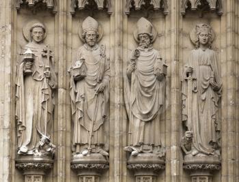 Four christian statues outside the cathedral of Our Lady in Antwerpen, Belgium
