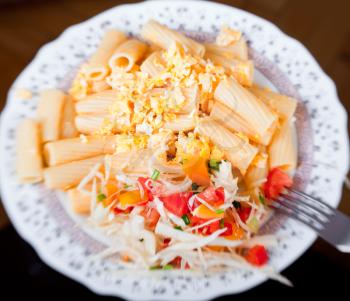 Pasta with salad from tomato and cabbage, selective focus
