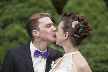 Just married couple kissing, closeup view
