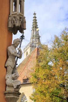 Noble crusader with spear above the fallen dragon statues in Rothenburg on Tauber, Germany
