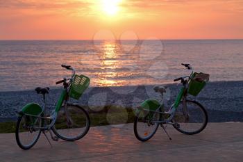 Two bicycles on Batumi beach, sunset
