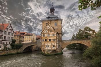 Obere bridge and Altes Rathaus and cloudy sky in Bamberg, Germany, sepia toned
