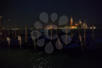 San Giorgio Maggiore island and venetian gondolas at night
