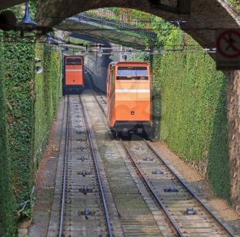 Two funiculars moving on the railroad in Bergamo, Italy
