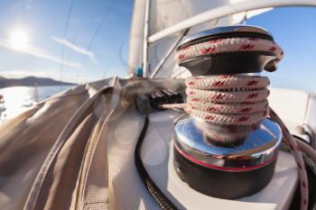 Winch with rope on sailing boat in the sea
