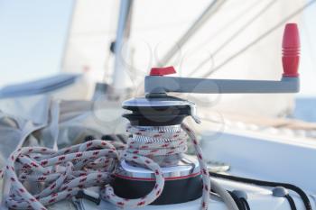 Winch with rope on sailing boat in the sea
