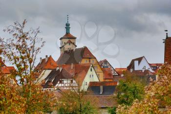 Rothenburg on Tauber cityscape with house roofs, cloudy top view
