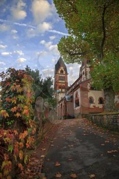St. Lutwinus church and road with leaves in Mettlach, Germany
