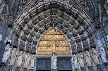 Statues of the saints above the entrance of Cologne cathedral, Germany
