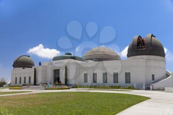 Griffith observatory with green grass field and sunny day
