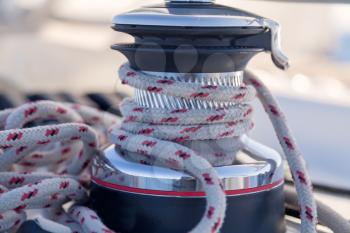 Winch with rope on sailing boat
