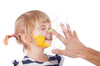 Small girl with paint on her cheek and nose and father's hand
