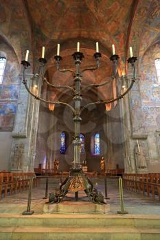 Ancient fresco and large candle inside the  Brunswick cathedral in Braunschweig, Germany
