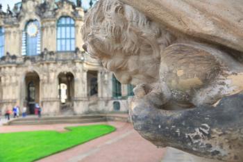 Closeup half naked faunus statue playing panpipe at Zwinger palace in Dresden, Germany
