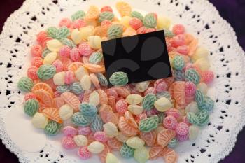 Candy background on the plate with black card