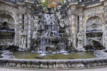 Fountain with faunus statues and streaming water at Zwinger palace, Dresden, Germany
