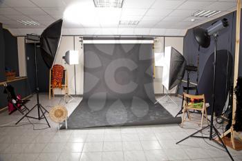 Professional studio interior with black background and nubmer of flashlights