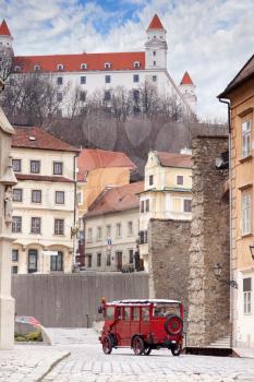 Stary Hrad - ancient castle and vintage car on old street in Bratislava, Slovakia
