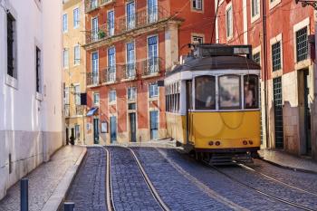 Vintage Lisbon tram on city street, sunny day, Portugal
