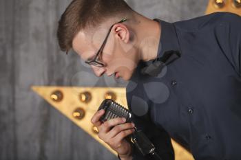 Young man singing with vintage microphone
