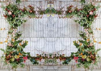 Vintage frame made from flowers, leaves with the grunge wooden background
