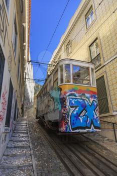 Vintage elevator with graffiti on old street, Lisbon, Portugal
